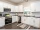 Updated kitchen with stainless steel appliances, white cabinets, and granite countertops at 3626 Cole Mill Rd, Charlotte, NC 28270