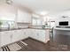 Bright, open kitchen with white cabinets, granite countertops, and stainless steel appliances at 3626 Cole Mill Rd, Charlotte, NC 28270