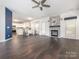 Open-concept living area with hardwood floors, a fireplace, and a view into the kitchen at 3626 Cole Mill Rd, Charlotte, NC 28270