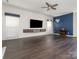 Stunning living room with dark hardwood flooring, custom blue accent wall, and modern ceiling fan at 3626 Cole Mill Rd, Charlotte, NC 28270