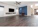 An expansive living room with dark hardwood floors, a ceiling fan, and a contemporary design at 3626 Cole Mill Rd, Charlotte, NC 28270