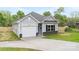 Charming one-story home with light gray siding, black shutters, and a one-car garage at 401 Groves St, Lowell, NC 28098