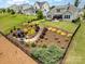 Landscaped backyard featuring tiered garden with stone steps leading to a patio at 4016 Spring Cove Way, Belmont, NC 28012
