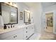 Well-lit bathroom with double sinks, modern fixtures, and a doorway to a walk-in closet at 4016 Spring Cove Way, Belmont, NC 28012