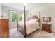 This bedroom features a four-poster bed and a bright window with natural light at 4016 Spring Cove Way, Belmont, NC 28012
