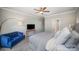 Spacious bedroom with a cozy blue loveseat, TV, and a large comfortable bed at 4016 Spring Cove Way, Belmont, NC 28012