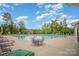 Community pool with lounge chairs, tables, and umbrellas, providing a relaxing outdoor experience at 4016 Spring Cove Way, Belmont, NC 28012