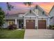 Charming home with a two-car garage, manicured lawn, and inviting curb appeal against a colorful sunset sky at 4016 Spring Cove Way, Belmont, NC 28012