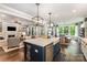 Bright and airy kitchen showcases a large island with bar seating and a view into the living and dining areas at 4016 Spring Cove Way, Belmont, NC 28012