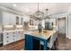 Modern kitchen features white cabinets, a central island with seating, and stainless steel appliances at 4016 Spring Cove Way, Belmont, NC 28012