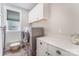 Functional laundry room equipped with modern washer, dryer, and storage cabinets at 4016 Spring Cove Way, Belmont, NC 28012