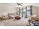 Bright living room boasts a ceiling fan, neutral colored walls, and multiple windows at 4016 Spring Cove Way, Belmont, NC 28012