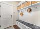 Practical mudroom with built-in storage, coat hooks, and a comfortable bench for convenience at 4016 Spring Cove Way, Belmont, NC 28012