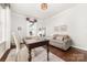 Bright office with hardwood floors, neutral paint, desk, couch, and a large window providing natural light at 4016 Spring Cove Way, Belmont, NC 28012