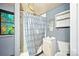 A full bathroom features shower, vanity, toilet, mirror, and a small window at 409 Rosemont Ave, Kannapolis, NC 28081