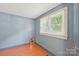 Cozy bedroom featuring hardwood floors and natural light from the window at 409 Rosemont Ave, Kannapolis, NC 28081