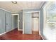 Bedroom features wood floors, a closet, and a door leading to another room at 409 Rosemont Ave, Kannapolis, NC 28081