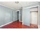 A bedroom with hardwood floors, a closet, and a door leading to another room at 409 Rosemont Ave, Kannapolis, NC 28081