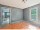 A bedroom with hardwood floors, a window, and a doorway leading to another room at 409 Rosemont Ave, Kannapolis, NC 28081