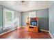 Bedroom features wood floors, two windows with blinds, and a TV on a stand at 409 Rosemont Ave, Kannapolis, NC 28081