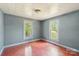 Bedroom features two windows and hardwood floors, bathed in natural light at 409 Rosemont Ave, Kannapolis, NC 28081