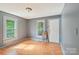 Sun-filled living room with gleaming hardwood floors and neutral paint at 409 Rosemont Ave, Kannapolis, NC 28081