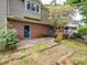 Exterior view of the home featuring a brick patio, a back door and some foliage at 4325 Wolf Pond Rd, Monroe, NC 28112