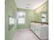 Spacious bathroom with double sink vanity, mosaic tile accents and large window at 4325 Wolf Pond Rd, Monroe, NC 28112