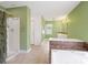Large bathroom featuring a shower and tub combination with white fixtures and green walls at 4325 Wolf Pond Rd, Monroe, NC 28112