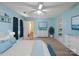 Serene bedroom with blue walls, carpet floors, built-in shelving, and a large window creating a peaceful retreat at 4325 Wolf Pond Rd, Monroe, NC 28112