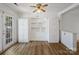 Bright breakfast nook with white cabinets, hardwood floors, natural light, ceiling fan and access to the backyard at 4325 Wolf Pond Rd, Monroe, NC 28112