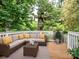 Inviting outdoor deck with comfortable seating and neutral tones, surrounded by lush greenery for a relaxing ambiance at 4325 Wolf Pond Rd, Monroe, NC 28112