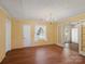 Inviting dining room featuring hardwood floors, a classic chandelier and ample natural light from windows, with access to the kitchen at 4325 Wolf Pond Rd, Monroe, NC 28112