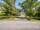 Charming home with gravel driveway and mature trees at 4325 Wolf Pond Rd, Monroe, NC 28112