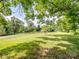 Expansive front yard showcasing lush greenery and mature trees, creating a serene outdoor space at 4325 Wolf Pond Rd, Monroe, NC 28112