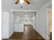 Spacious kitchen with white cabinetry, hardwood floors and modern appliances, seamlessly connecting to the breakfast area at 4325 Wolf Pond Rd, Monroe, NC 28112
