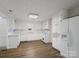 Bright kitchen featuring white cabinets, hardwood floors, modern appliances and ample counter space at 4325 Wolf Pond Rd, Monroe, NC 28112