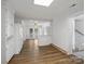 Open kitchen layout with white cabinets, hardwood floors, natural light and an adjacent breakfast nook, perfect for casual dining at 4325 Wolf Pond Rd, Monroe, NC 28112