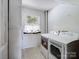 Functional laundry room with modern washer and dryer units and a window with curtains at 4325 Wolf Pond Rd, Monroe, NC 28112