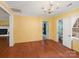 Bright living room with hardwood floors, chandelier lighting, and access to the bathroom and other rooms at 4325 Wolf Pond Rd, Monroe, NC 28112