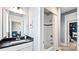 Stylish bathroom showcasing a vanity, large mirror with lighting and a walk-in shower at 4444 Moxie Way, Charlotte, NC 28215
