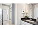 Modern bathroom featuring a dark countertop, white cabinetry, and neutral toned tile at 4444 Moxie Way, Charlotte, NC 28215