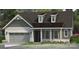 Charming single-story home with a gray brick facade, attached two-car garage and a covered front porch at 4444 Moxie Way, Charlotte, NC 28215