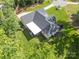 Aerial view of a beautiful home with an expansive yard and pristine landscaping, surrounded by lush greenery at 518 Maynard Farm Ln, Stanley, NC 28164