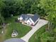 An aerial view of a well-kept lawn and home surrounded by lush trees and greenery at 518 Maynard Farm Ln, Stanley, NC 28164