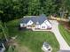 Aerial view of a beautiful home with an expansive yard and pristine landscaping, surrounded by lush greenery at 518 Maynard Farm Ln, Stanley, NC 28164