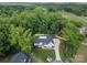 An aerial view of a well-kept lawn and home surrounded by lush trees and greenery at 518 Maynard Farm Ln, Stanley, NC 28164