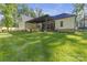 Expansive backyard with green lawn, patio, pergola and outdoor kitchen at 518 Maynard Farm Ln, Stanley, NC 28164