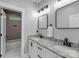 Modern bathroom with dual sinks, granite countertops, and sleek black hardware at 518 Maynard Farm Ln, Stanley, NC 28164