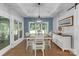 Elegant dining room features tray ceilings, hardwood floors, wainscoting, and ample natural light through large windows at 518 Maynard Farm Ln, Stanley, NC 28164
